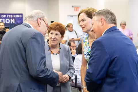 Senator Schumer shakes hands with local elected officials before press conference at ETEC.