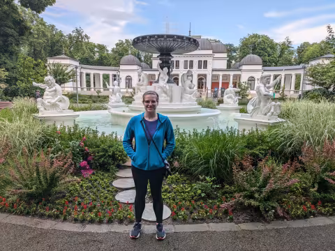 Emily Mains stands in front of a fountain in Cluj, Romania.