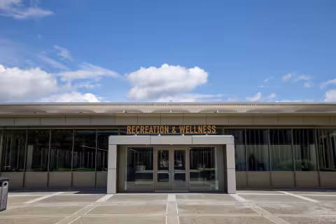 A building entrance with the words Recreation & Wellness above the door.