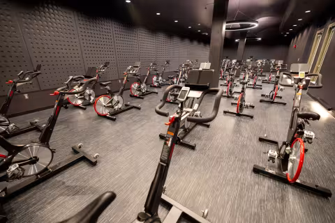 A group exercise room filled with indoor cycling machines.