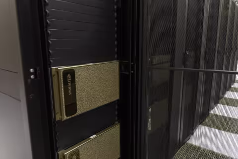 A close-up photo of a silver box inside a computer server rack.