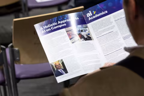 A brochure discussing UAlbany's artificial intelligence initiative is seen during R&E Week in October, 2024 at UAlbany.