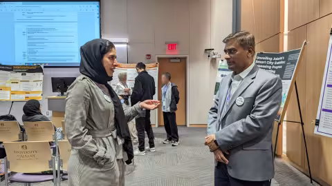 Two information science doctoral student in discussion.