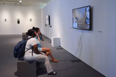 visitors sitting watching a video