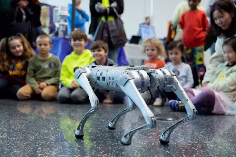 Children watch a robotic dog demonstration at the  STEM and Earth Sciences Family Day.