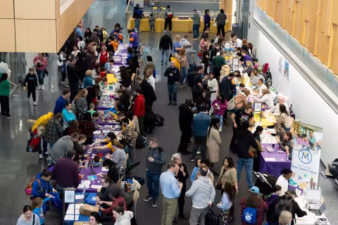 A large crowd gathers inside the ETEC atrium for STEM and Earth Sciences Family Day.