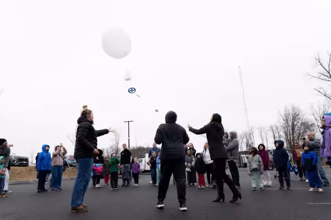 Students launch a weather balloon from the ETEC parking lot during STEM and Earth Sciences Family Day.