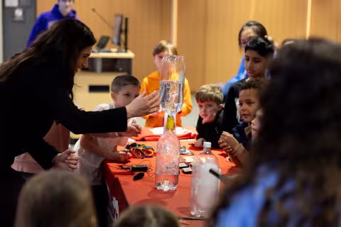 WNYT's Christina Talamo leads a tornado in a bottle experiment at STEM and Earth Sciences Family Day.