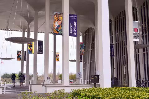 Wayfinding banners on columns next to the museum entrance 