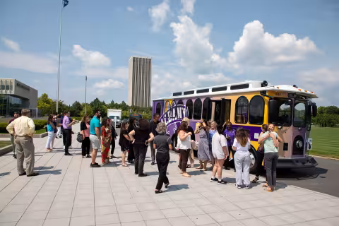 A group of people waiting to get on the trolley