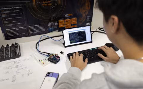 A student reviews code on a tablet from the Cyber Resilient Interdependent Systems & Infrastructure Solutions Lab at ETEC. (photo by Patrick Dodson)