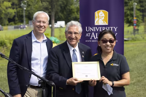 Sen. Jim Tedisco offers a proclamation to Mesonet leaders Chris Thorncroft and June Wang.
