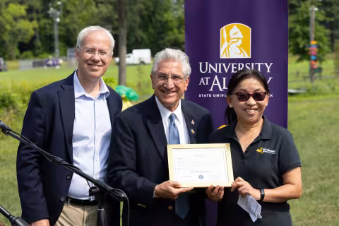 Sen. Jim Tedisco offers a proclamation to Mesonet leaders Chris Thorncroft and June Wang.