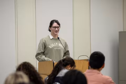 Third-year senior Jess speaks at podium