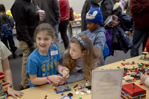 Children work together to build a rocket ship during the CEHC Lego event.