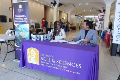 Students check in people at UAlbany's GIS Day celebration.