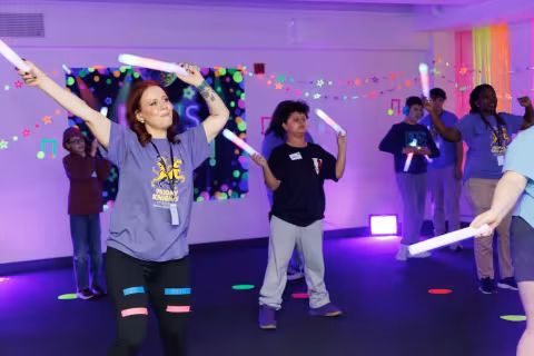Children and volunteers participate in games and activities.