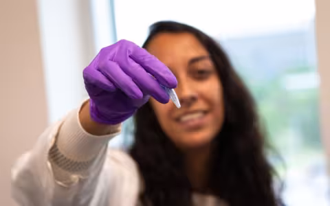 Sujata Murty displays a crushed coral sample that is ready for testing.