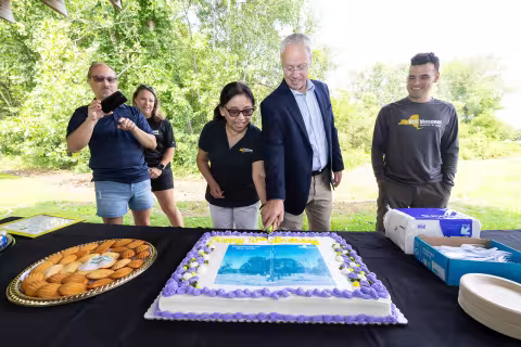 Mesonet leaders cut a cake to celebrate the Schuylerville site's 10th birthday.