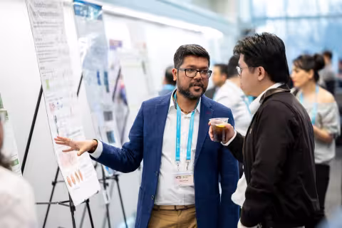 A student shares his poster during the 2026 International Congress on Biophotonics.
