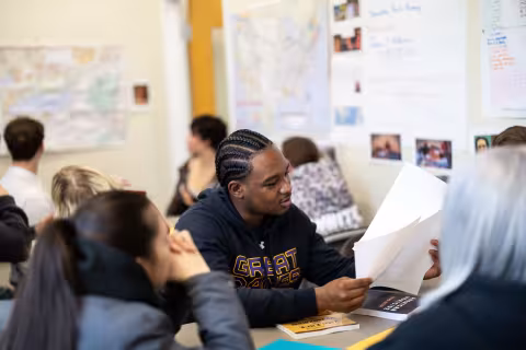 An image of two students looking at a piece of paper.