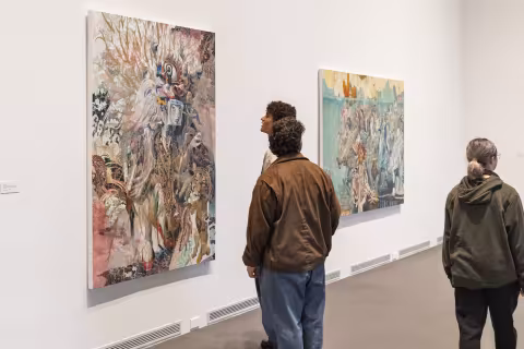 Visitors looking at paintings