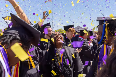 Students celebrating in confetti at the end of the commencement ceremony.