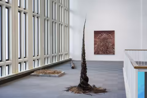 Foreground: Sculptures made from hair, burlap and neckties. Background: Painting on oil