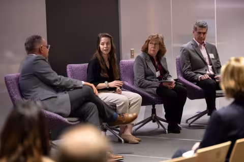 Four researchers sit on stage and participate in a panel discussion during R&E Week 2023.