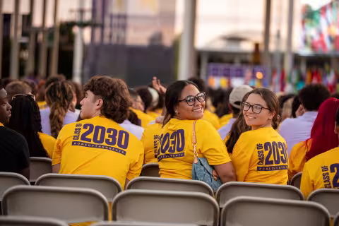Students wearing gold class of 2030 tshirts attending Convocation.