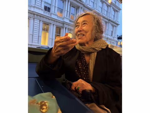 Poet Mei-mei Berssenbrugge smiling at a cafe