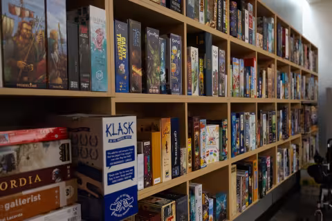 A bookshelf with games is shown in the Game Hub.