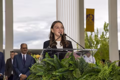 Senior Alexa Taleporos offers remarks at the Damien statue unveiling.