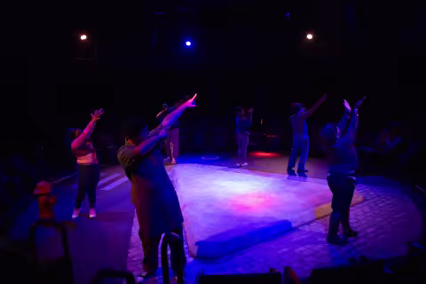 The actors performing "The Drunken City" point off stage following a dress rehearsal at UAlbany indoors
