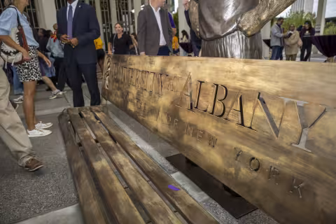 A bench with the University at Albany engraved on it.