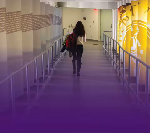 A student walking through the Massry School of Business donor tunnel.