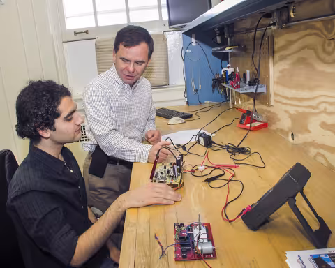 Two researchers working in a UAlbany computer engineering lab.
