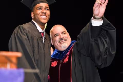 cehc dean griffin with student at graduation 