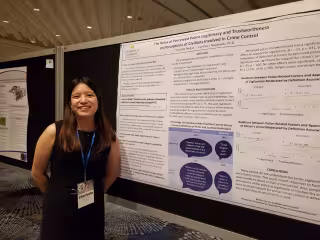 Melissa Anderson with her poster projects at APS 2025.
