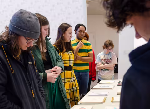 Students in the First Year Experience Seminar Why Museums? review their final project during class in the UAM.