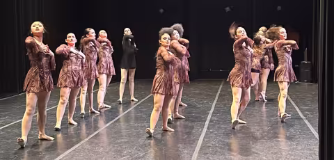University at Albany Dance Council dancing together on stage.