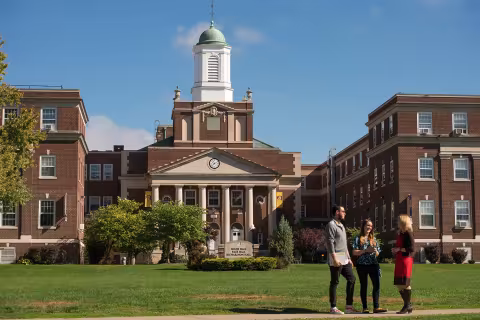 Students speak to a faculty member on the Downtown Campus.