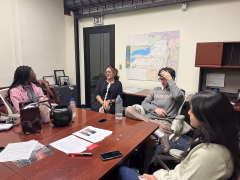 Legislative Gazette interns sit around a table inside the New York State Capitol.