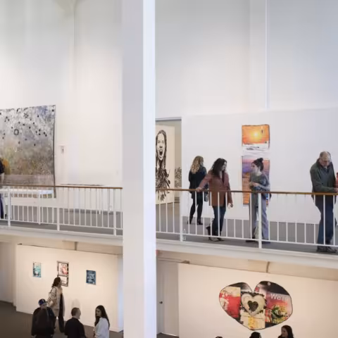 Visitors in the museum looking at artworks.