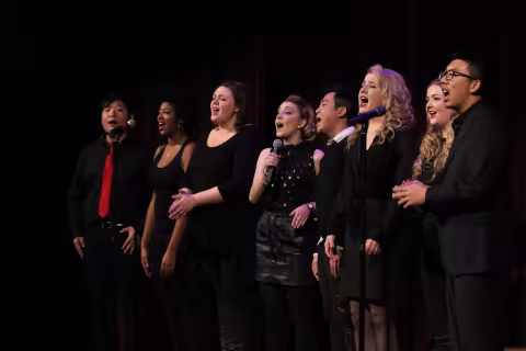 A group of students singing in a music performance.