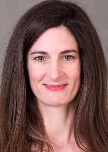 headshot of smiling woman with long brown
