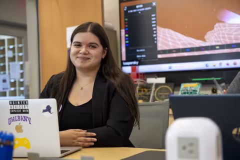 Olivia BenAoumeur sits behind a laptop in the Cybersecurity and Cryptography Lab.