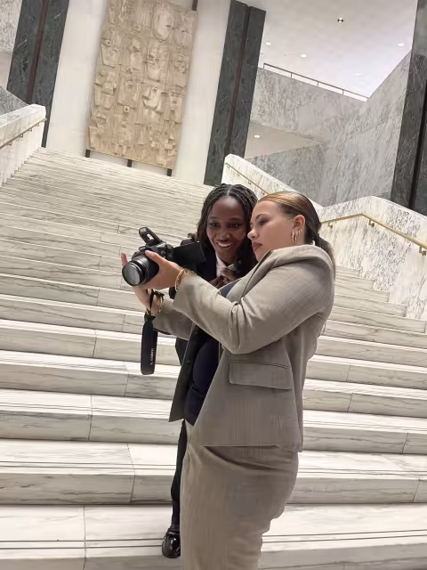 UAlbany student Tamia Bonner reviews a photo from inside the State Capitol Building.