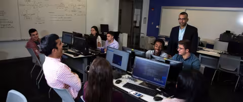 Sanjay Goel presenting to students in a digital forensics lab.