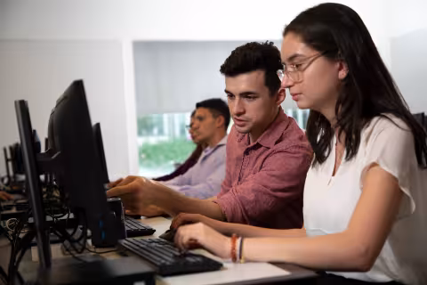 Students collaborating on cyber research project